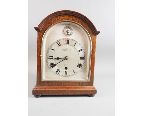 An early 20th century German mahogany cased mantel clock, supplied by Kleyser &amp; Co, London, arched silver dial with 6" di