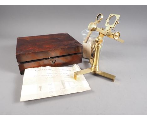 A 19th century brass pocket compound microscope, with concave mirror and single lens condenser, on folding tripod stand with 