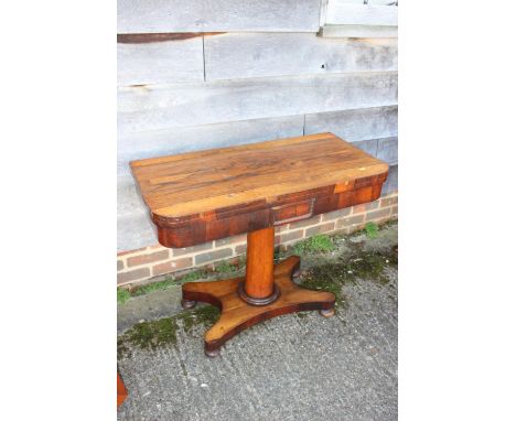 A 19th century rosewood card table, on turned column, four shaped supports and bun feet, 36" wide x 35" deep x 29 1/2" high o