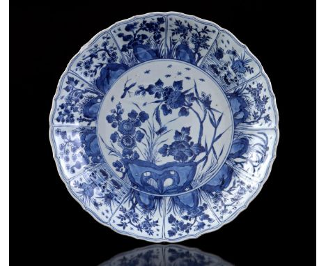 Porcelain dish with blue decor of flowers and insects in a landscape and 12 cartouches with floral decor on the edge, China K