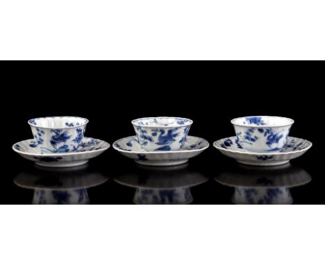 3 porcelain cups and saucers in relief with different decors of moon hare in landscape surrounded by 2 storks with something 