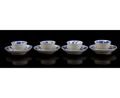 4 porcelain cups and saucers with Cafe-au-lait on the outside and floral decor on the inside, surrounded by a city with city 