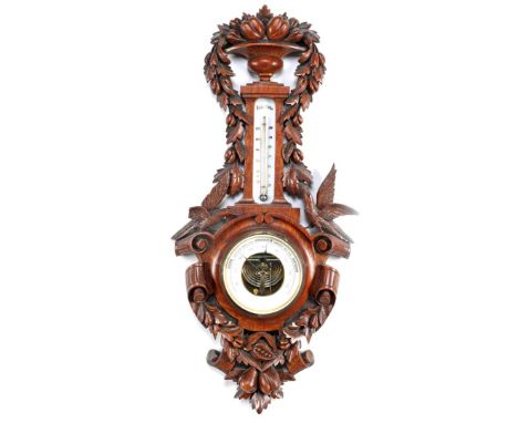 Dutch barometer in richly decorated oak case 67 cm high, 31 cm wide (piece of bird's wing missing)