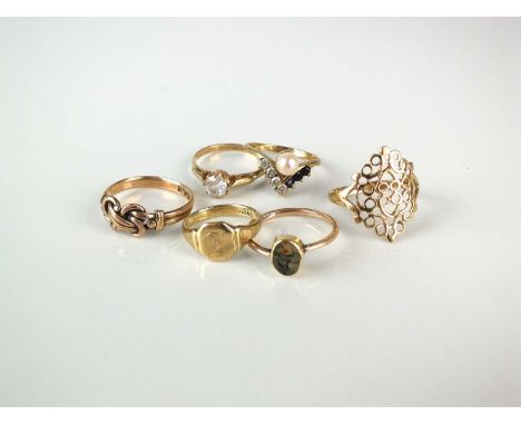 A collection of six rings, comprising; a 9ct gold stylised knot ring, size M 1/2, a 9ct gold cultured pearl and sapphire ring