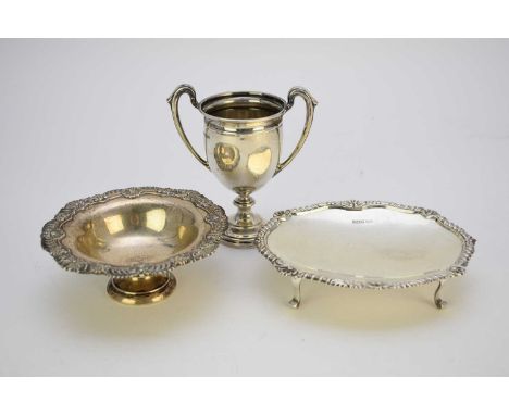 A silver two handle trophy cup, Mappin &amp; Webb, Sheffield 1929, 12cm high, together with a silver pedestal circular dish, 