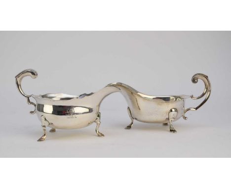 A George II silver sauce boat, John Pollock, London 1749, of typical form with acanthus leaf capped scroll handle and raised 