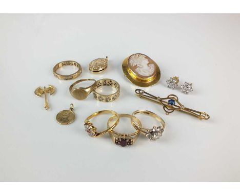 A small collection of jewellery, comprising; a 9ct gold garnet ring, a 9ct gold white paste cluster ring (lacking one stone),