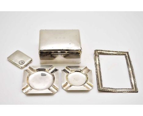 Two silver ash trays, each of canted square form with engine turned decoration, together with a silver mounted cigarette box,