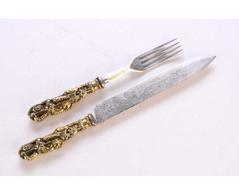 A white metal and gilt metal 'George and Dragon' knife and fork, the figural gilt metal handles depicting Saint George on hor