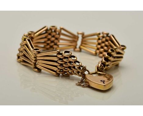 An 18ct gold gate link bracelet, with heart shaped padlock clasp and attached safety chain, weight approx 32gCondition:Bracel