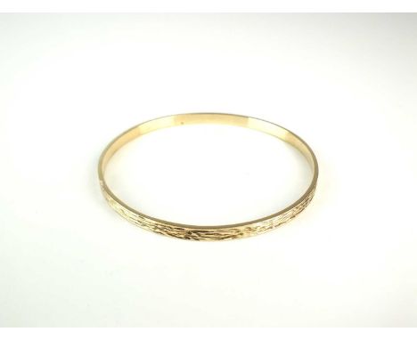 A 9ct gold textured bangle, inner diameter approx 63mm, weight approx 12.2g
