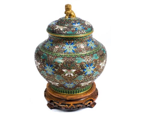A late 19th century Chinese champleve enamel vase: of ovoid form with stepped, domed cover having a gilt metal temple dragon 