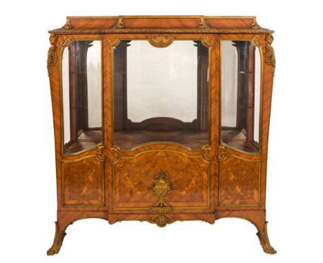 A late 19th Century French kingwood, parquetry, marquetry and gilt metal mounted vitrine:, of breakfront outline with acanthu