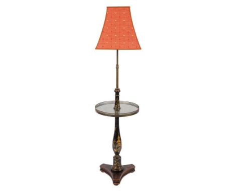A black lacquer and gilt chinoiserie standard lamp:, with brass stem surmounted by a coral patterned shade, the circular pier