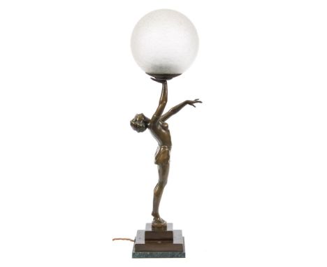 An Art Deco period bronzed metal lamp in the form of a semi naked female gymnast: standing with her head tilted back and her 