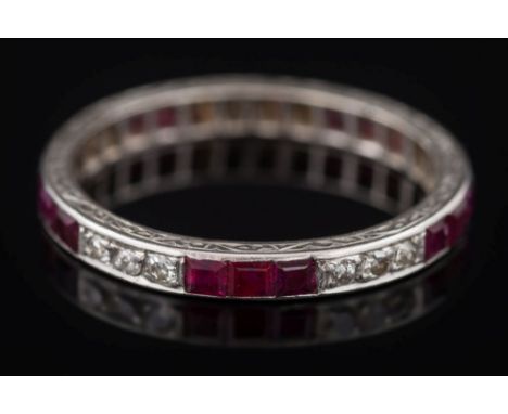 A ruby and diamond eternity ring: with rows of calibre-cut rubies and circular-cut diamonds, later re-sized with additional s