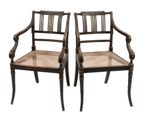 A pair of Regency ebonised beechwood and gilt wood and decorated elbow chairs:, the backs with curved cresting rails painted 