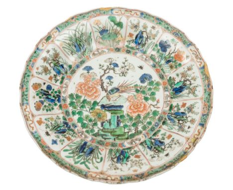 A group of three Chinese famille verte dishes and bowls: brightly enamelled with either birds and peony stems or lotus lappet