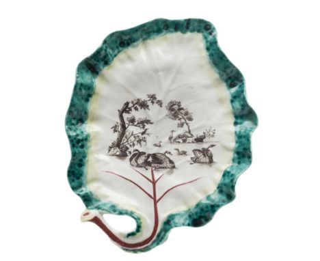 A First Period Worcester leaf dish: with stalk handle and puce veining, the rim edged in yellow and mottled green, the centre