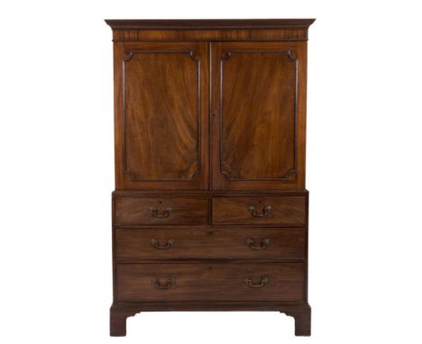 A George III mahogany linen press:, the upper part with a moulded cornice, fitted with sliding trays enclosed by a pair of mo