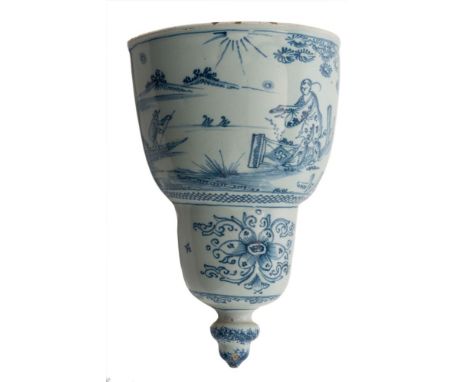 A London blue and white delftware wall pocket: of D form with slightly concave back, painted with a Chinese figure standing b