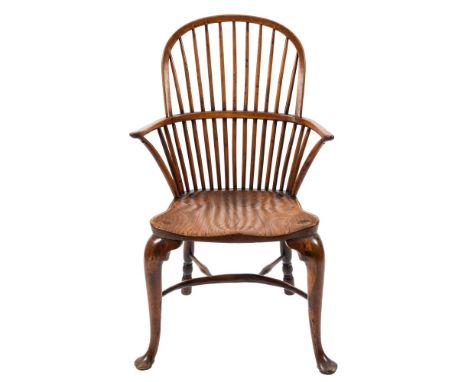 An 18th Century yew-wood and elm stick back Windsor elbow chair:, with an arched top rail and shaped solid seat, on cabriole 