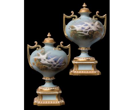 A pair of Royal Worcester two-handled vases and covers painted by Charles Baldwyn: each with swans in flight against a water 