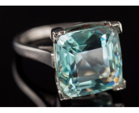 An 18ct white gold and aquamarine single-stone ring: the cushion-shape aquamarine 13.2mm long x 13mm wide x 9.5mm deep, in fo