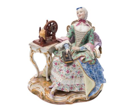 A Meissen porcelain figure of 'The Good House Keeper': modelled after the original by Kaendler seated wearing a headscarf, fl