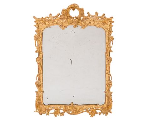 A late 19th Century carved giltwood cartouche-shaped wall mirror:, with pierced acanthus scroll cresting, the surround with a