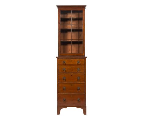 A mahogany secretaire bookcase:, of small size, the upper part with a moulded and reeded cornice, enclosed by a glazed panel 