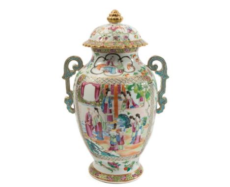 A Canton porcelain two handled vase and cover: of footed oviform with domed petal shaped cover and berry knop enamelled front