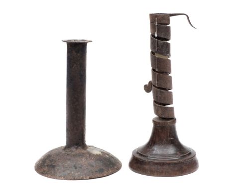 An 18th Century Scottish fruitwood and iron candlestick and a plain metal candlestick: the first with adjustable spiral steel