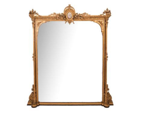 A mid 19th Century giltwood and gesso overmantel mirror:, surmounted by a central oval Sevres-style plaque depicting a female