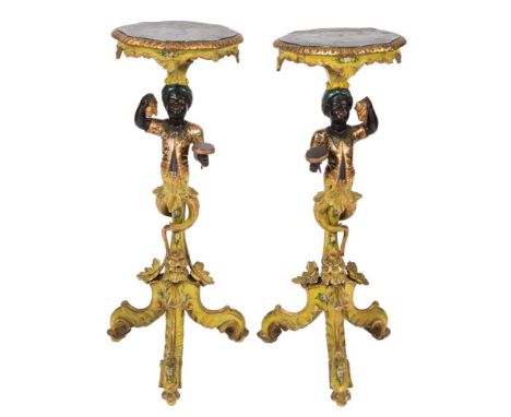 A pair of late 19th/early 20th Century Venetian carved wood and decorated Blackamoor stands,: the simulated green variegated 