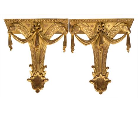 A pair of carved giltwood wall brackets,: the rectangular tops with egg and dart borders on tapered and scale decorated suppo