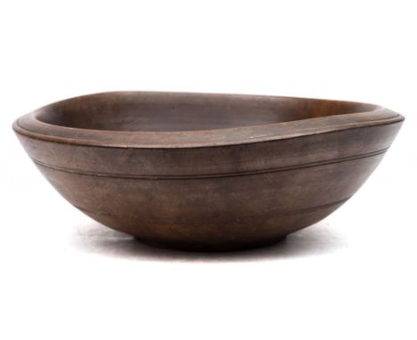 A 19th century sycamore treen dairy bowl: the exterior with double ring bands and raised foot rim, 42 cm diameter.