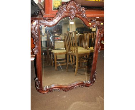 A CARVED DECORATIVE WOODEN MIRROR