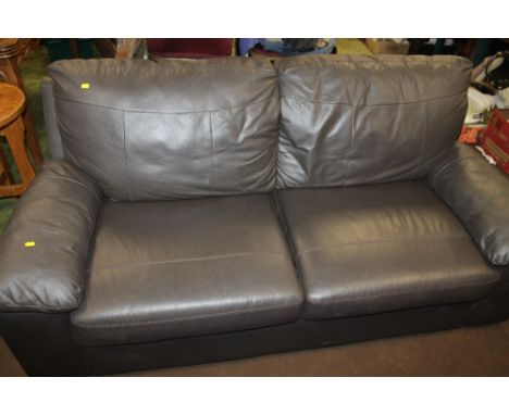 A TWO SEATER LEATHER SOFA 
