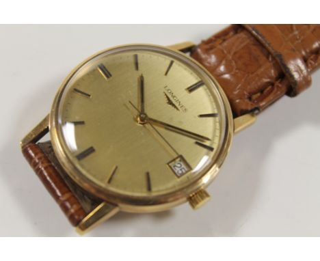 A GENTS GOLD LONGINES MANUAL WRIST WATCH, WITH LEATHER STRAP