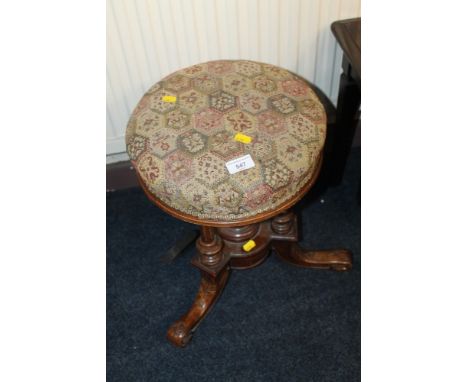 AN UPHOLSTERED PIANO STOOL 