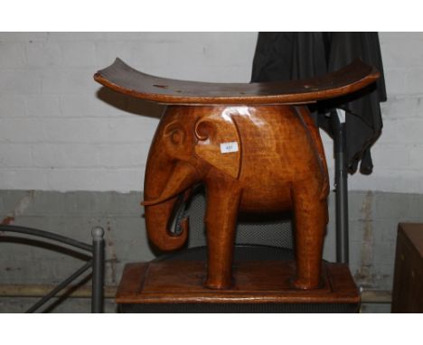 A CARVED STOOL IN THE FORM OF AN ELEPHANT 