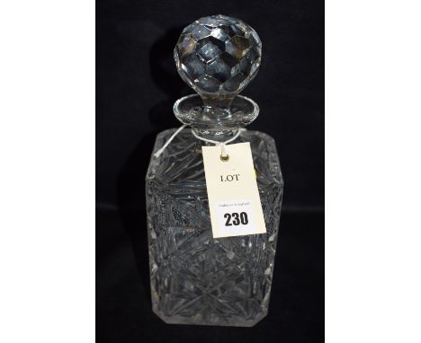 A cut-glass decanter of square form.