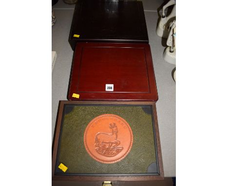 Three stained wood and other coin collectors coin cases, one by K. Rugerrand.