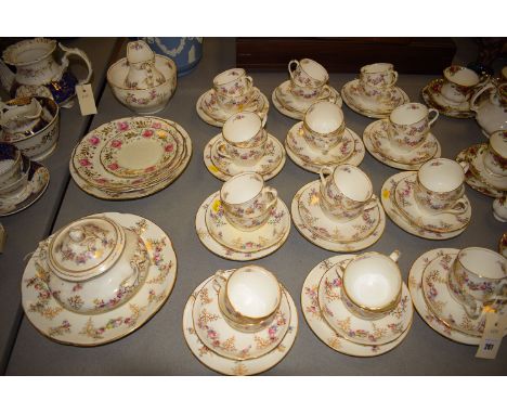 A late 19th Century salon part tea and coffee service, decorated sprays of flowers with gilded highlights on white ground. 