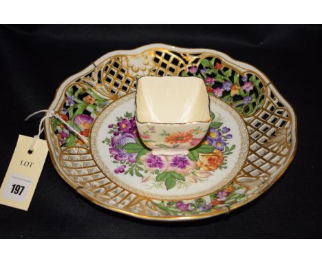 A Dresden style ceramic fruit dish with shaped and pierced border, with hand-painted floral and trellis decoration, with cent