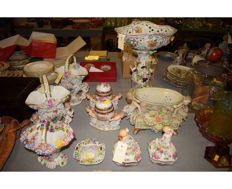 Continental style ceramic table centre-piece with pierced oval bowl encrusted with floral decoration and painted flowers on a