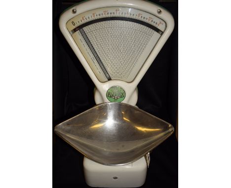 An Avery shop balance, chrome metal weighing pan and white enamel finish.
