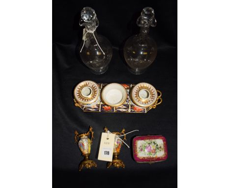 A pair of small decanters with cut stoppers and necks, with starcut bases; an early 19th Century Derby pen and ink stand deco