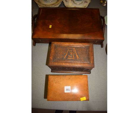 A Georgian mahogany tea caddy with hinged shaped top cover, opening to reveal two compartments with slightly domed lids; toge